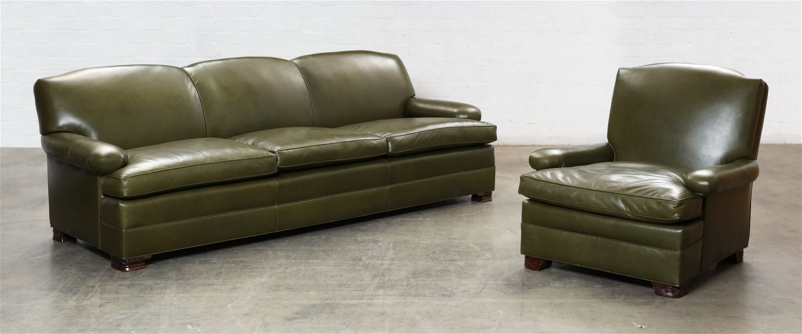 A GREEN LEATHER UPHOLSTERED SOFA