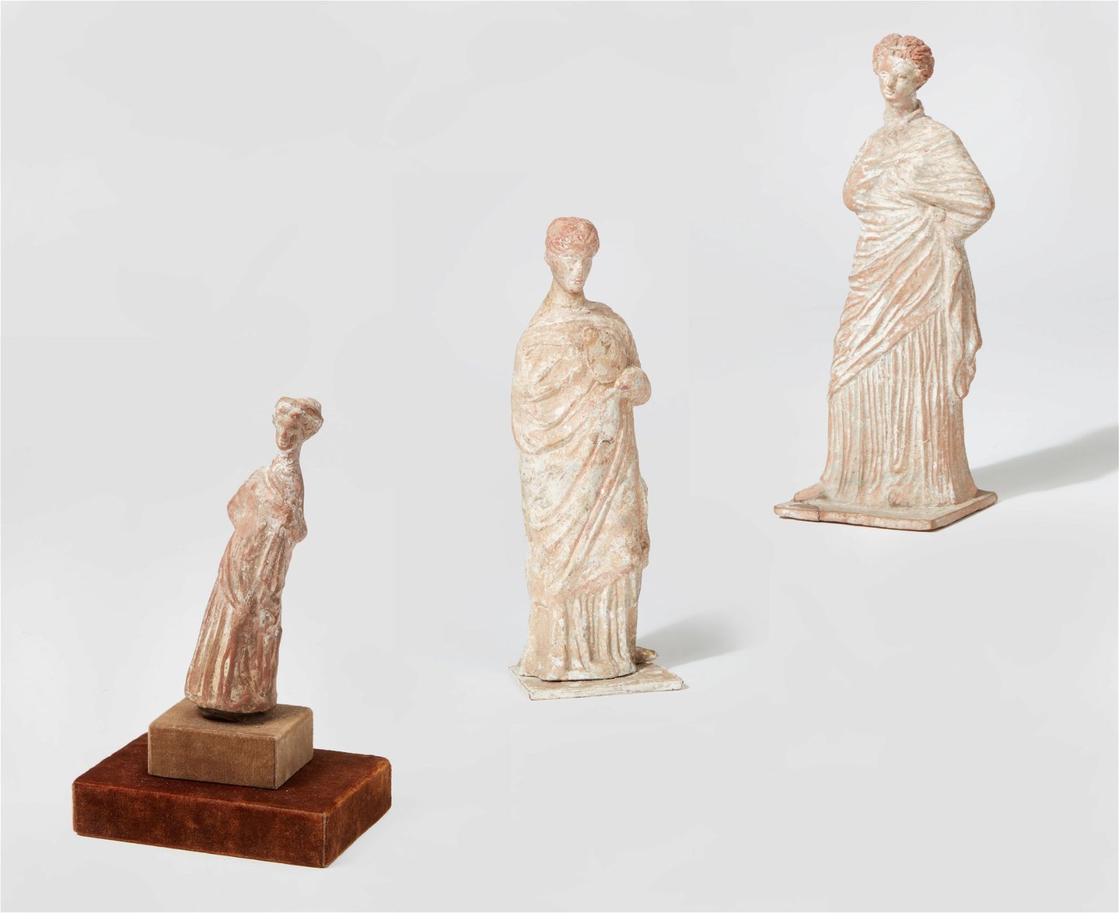 THREE GREEK TERRACOTTA FEMALE FIGURESThree