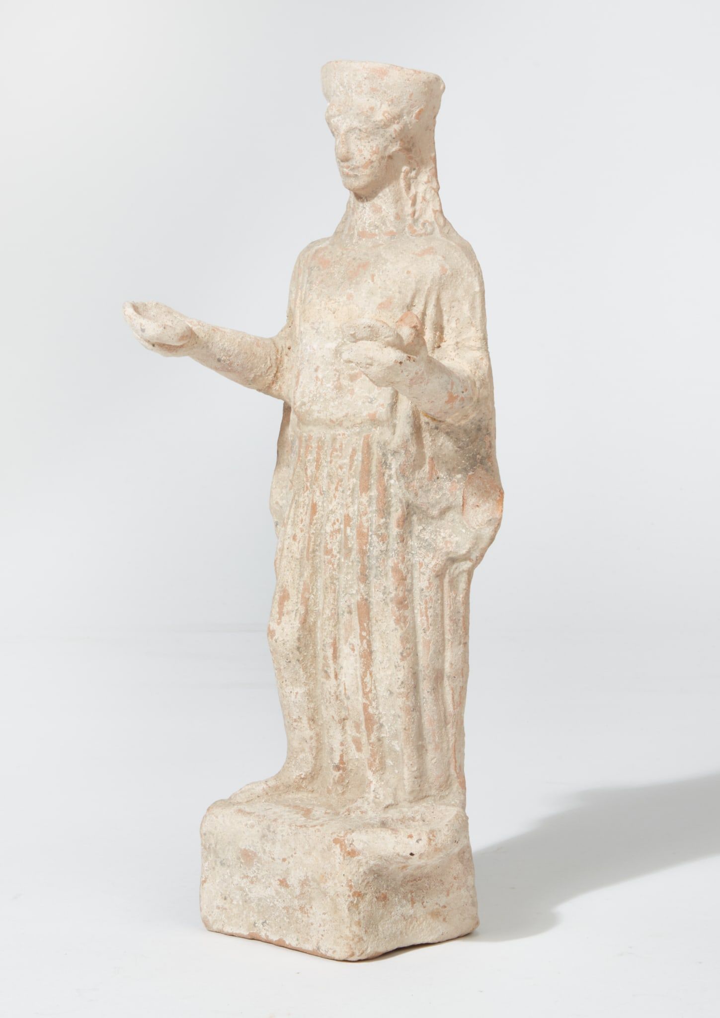 A GREEK TERRACOTTA FEMALE FIGUREA