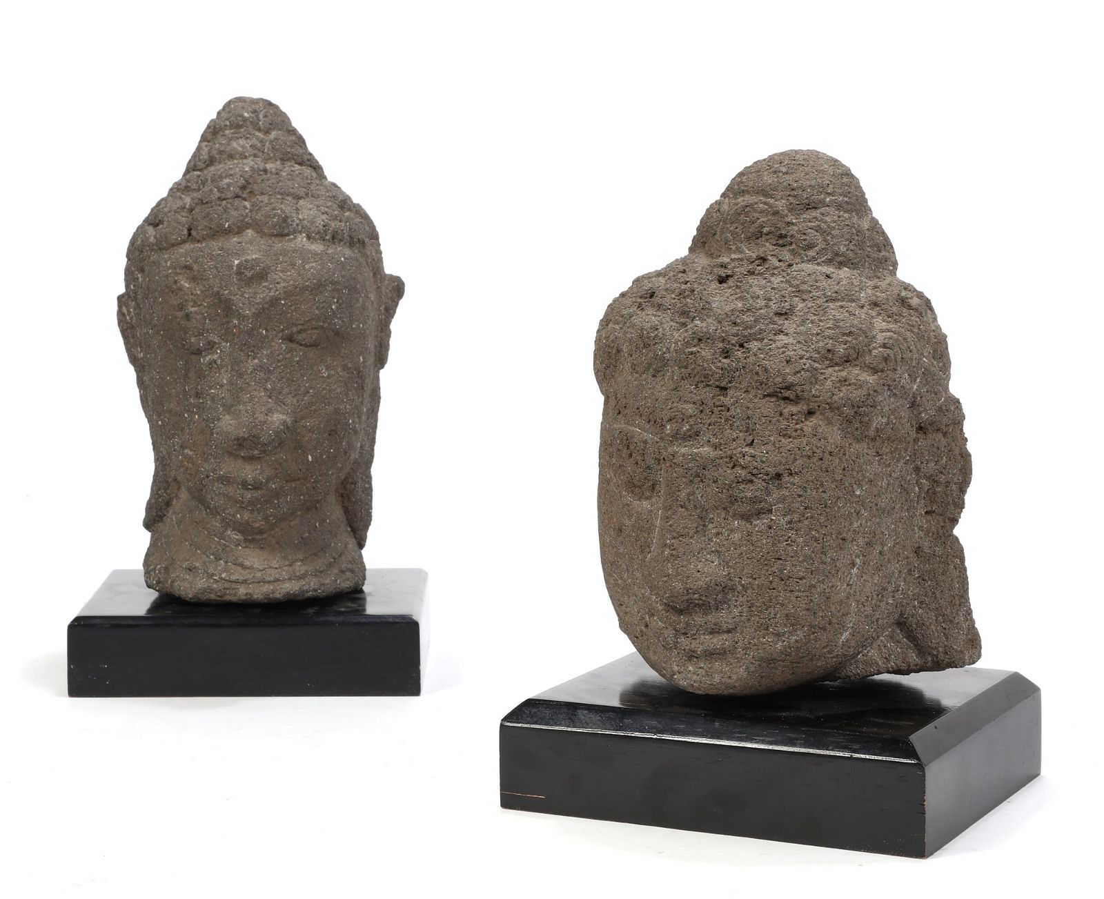 TWO CARVED STONE HEADS OF BUDDHATwo
