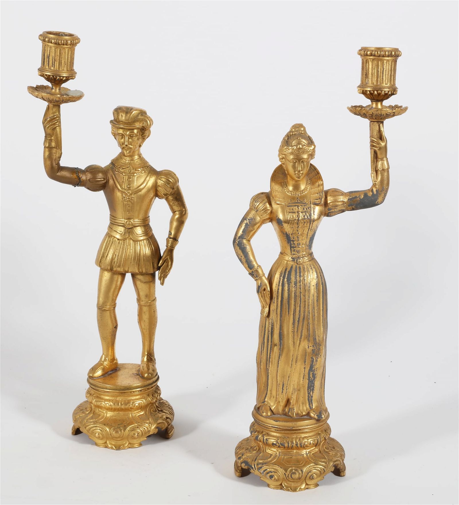 A PAIR OF GILT METAL FIGURAL CANDLESTICKSA