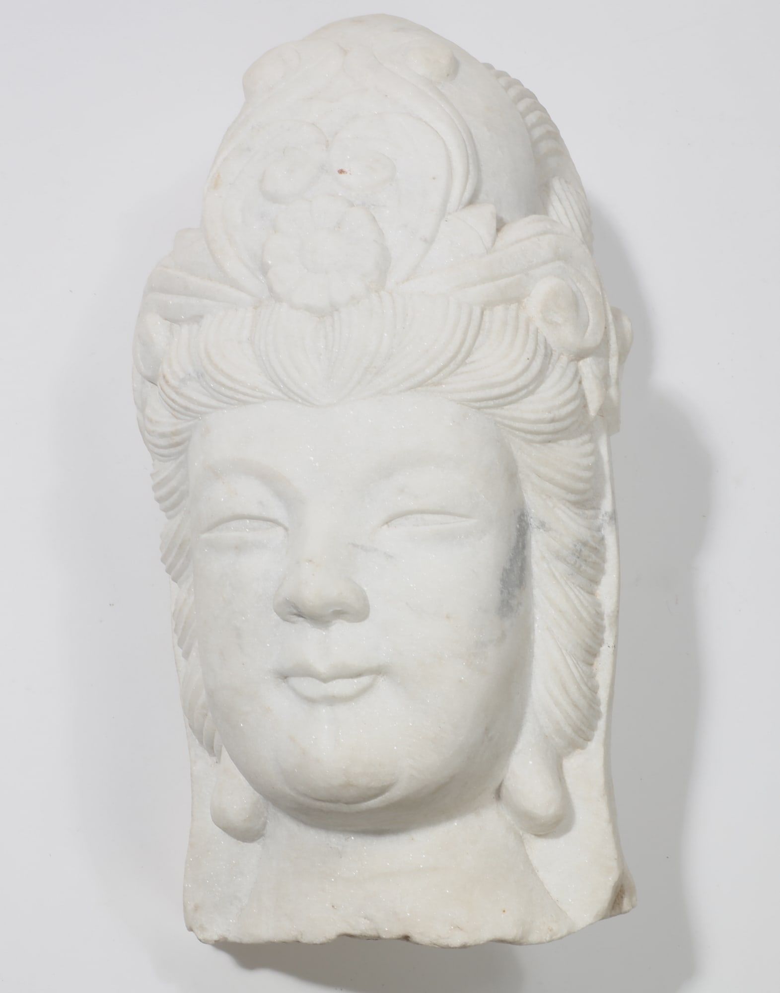 A CHINESE CARVED WHITE MARBLE HEAD