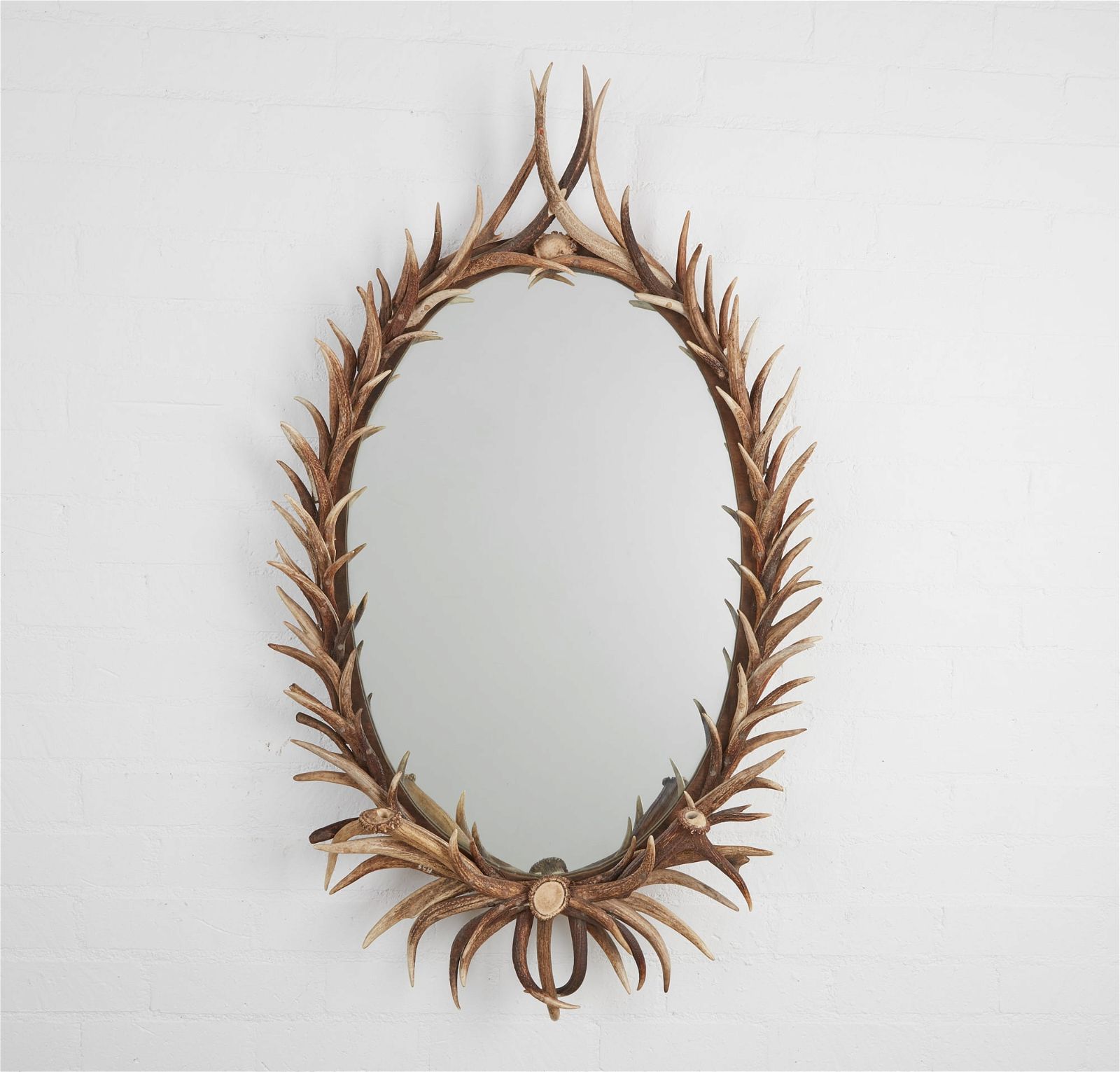 AN OVAL ANTLER FRAME MIRRORAn oval