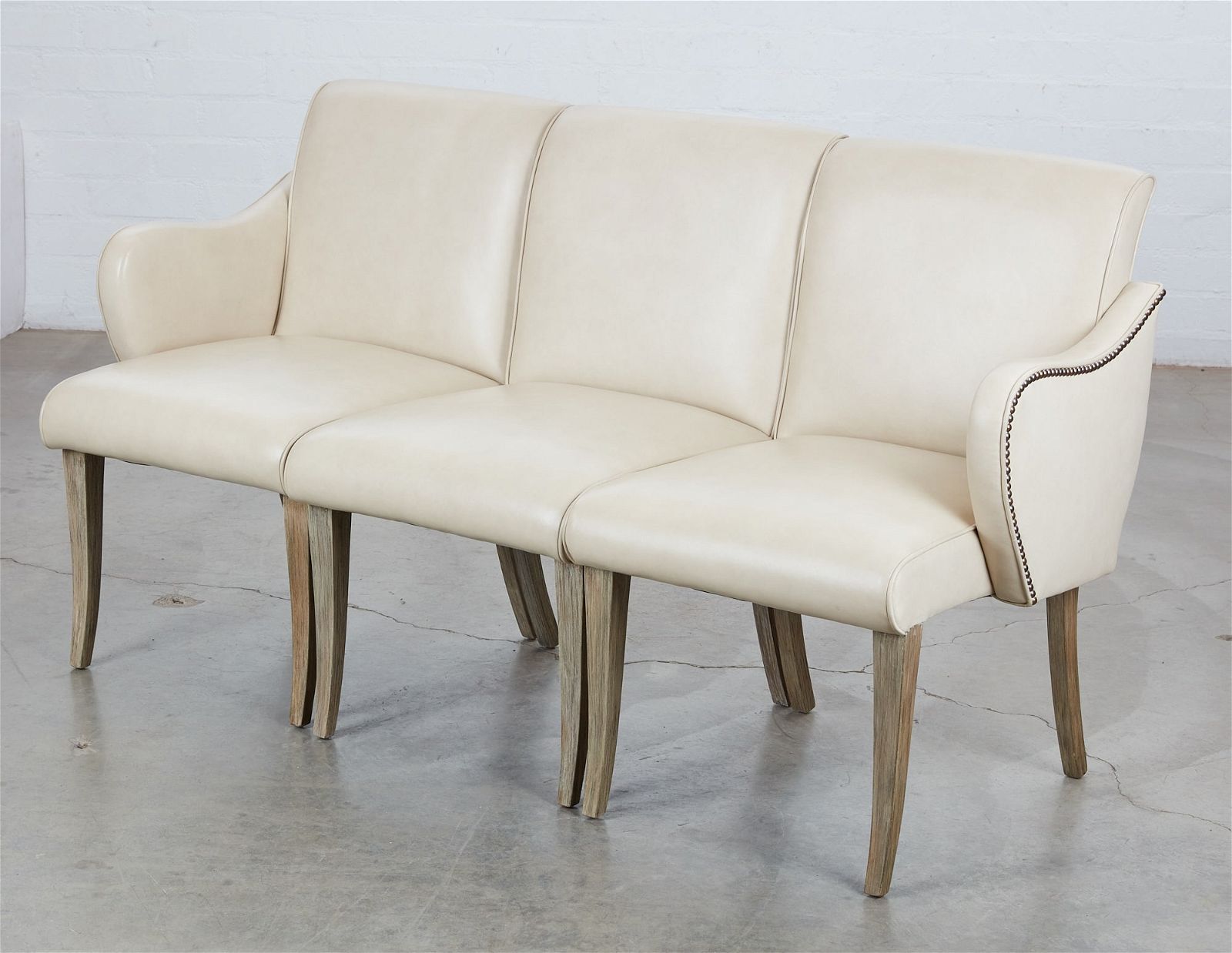 A FRENCH UPHOLSTERED THREE SEAT