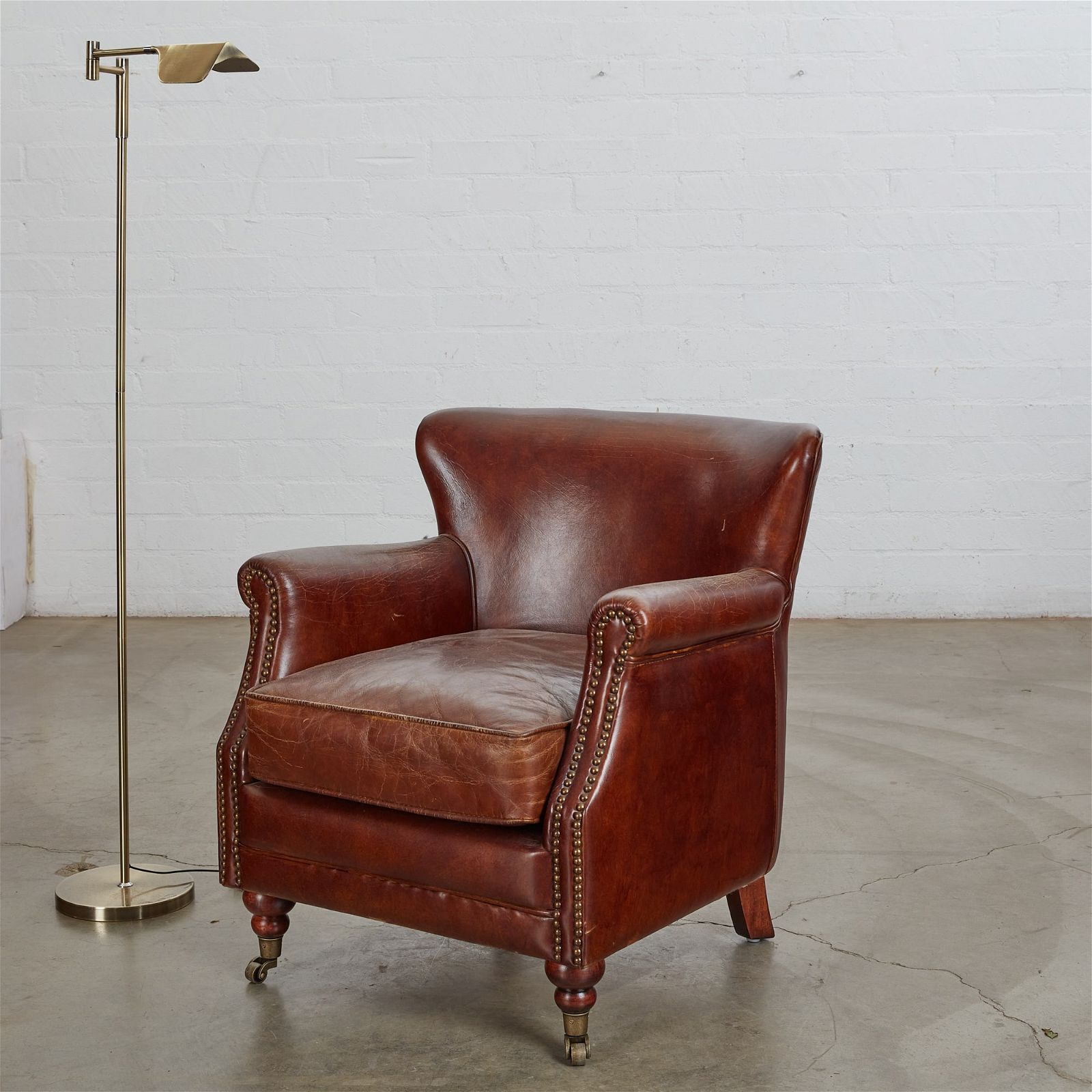 A BROWN LEATHER ARMCHAIR AND READING
