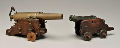 Two brass signal cannons: one cap fired,