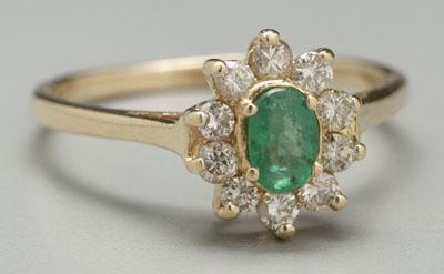 Emerald and diamond ring, one oval-faceted