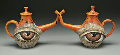 Two Michael Lucero eye teapots: