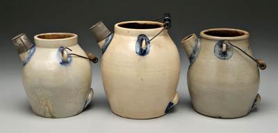 Three stoneware batter pitchers, all