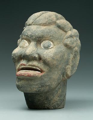 Carved stone head of black man,