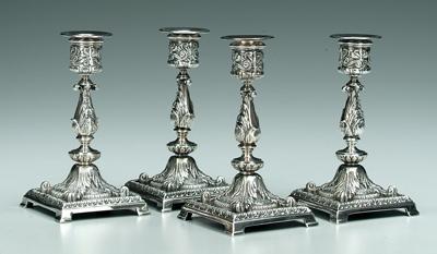 Four silver plated candlesticks: