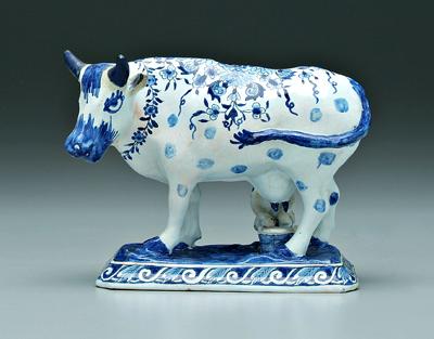 Delft figure, man milking cow: blue