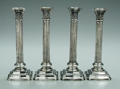 Four Wallace sterling candlesticks: