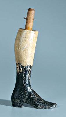 Carved and painted wooden leg,