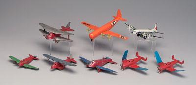 Eight toy airplanes: six painted