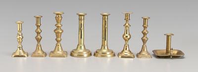 Eight brass candlesticks: one pair
