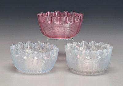 Three latticino glass bowls: two white,