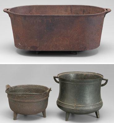 Three cast iron pots: one with three