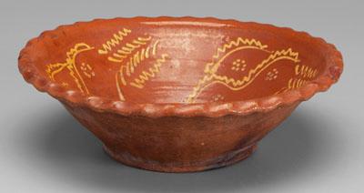 Slip-decorated redware bowl, crimped