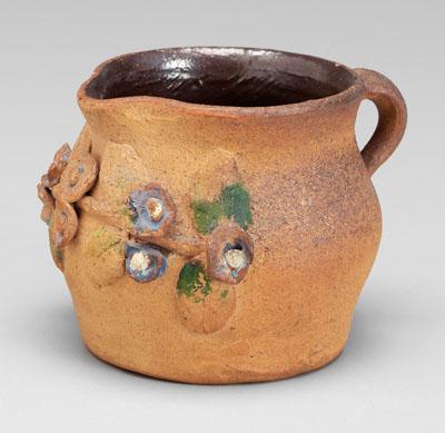 Brown Pottery pitcher, applied flowers