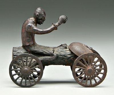 Pull toy, black man riding log,