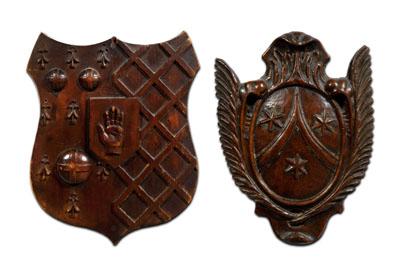 Two carved wooden shields: one