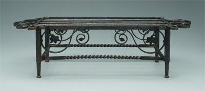 Iron trivet, spiral and floral decoration