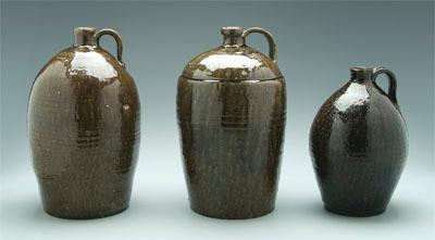 Three stoneware jugs: runny dark