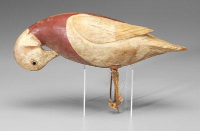 Carved and painted wooden duck, in preening