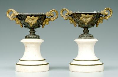 Pair cast metal urns: marble bases,