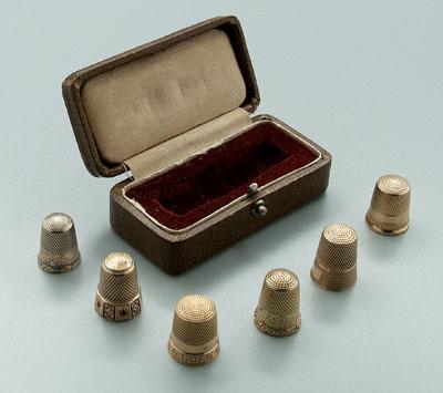 Six 10 kt. gold thimbles: one with