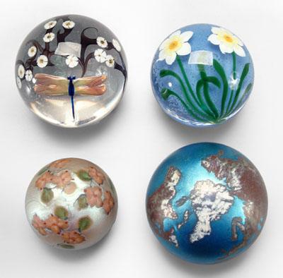 Four art glass paperweights: one with