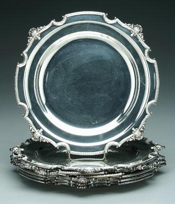 Seven silver plated service plates: