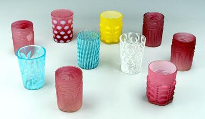 Ten glass tumblers: five red satin glass,