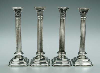 Four Wallace sterling candlesticks:
