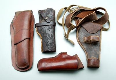 Four Heiser leather holsters: one