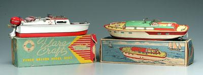 Two toy boats, cabin cruisers: