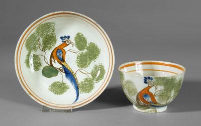 Spatterware cup and saucer: peafowl