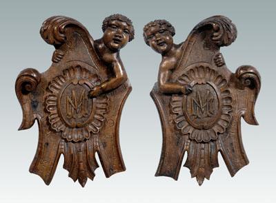 Pair carved cherub plaques: cherub