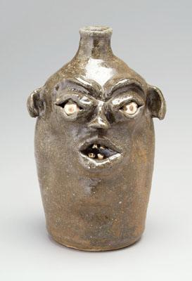 Stoneware face jug, ceramic eyes