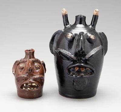 Two E.J. Brown redware face jugs