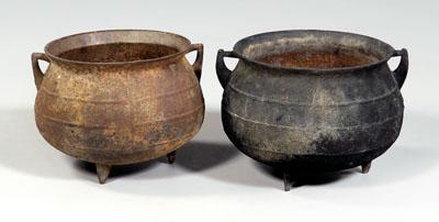 Two cast iron pots: one four-gallon