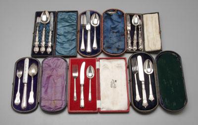 Six cased English silver child sets: