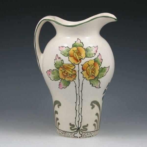 Avon Faience handled pitcher with squeezebag-decorated