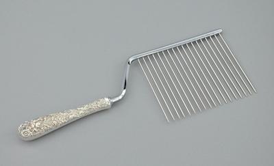 An Angelfood Cake Slicer With A Sterling