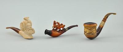 A Group of Three Carved Smoking