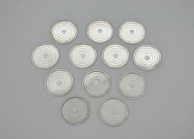 A Set of Sterling Silver Coasters by