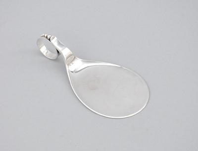 A Sterling Silver Server With a circular