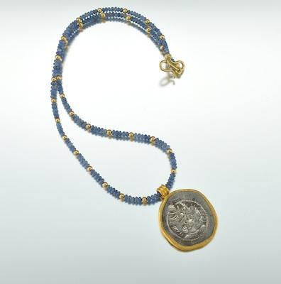 A Sapphire, 18k Gold and Antique Coin