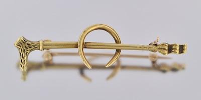 An Antique 14k Riding Crop Brooch,